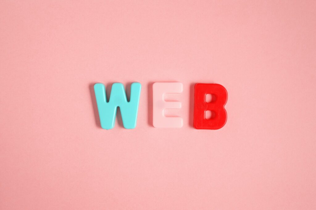 Plastic magnetic letters. The Word web on pink