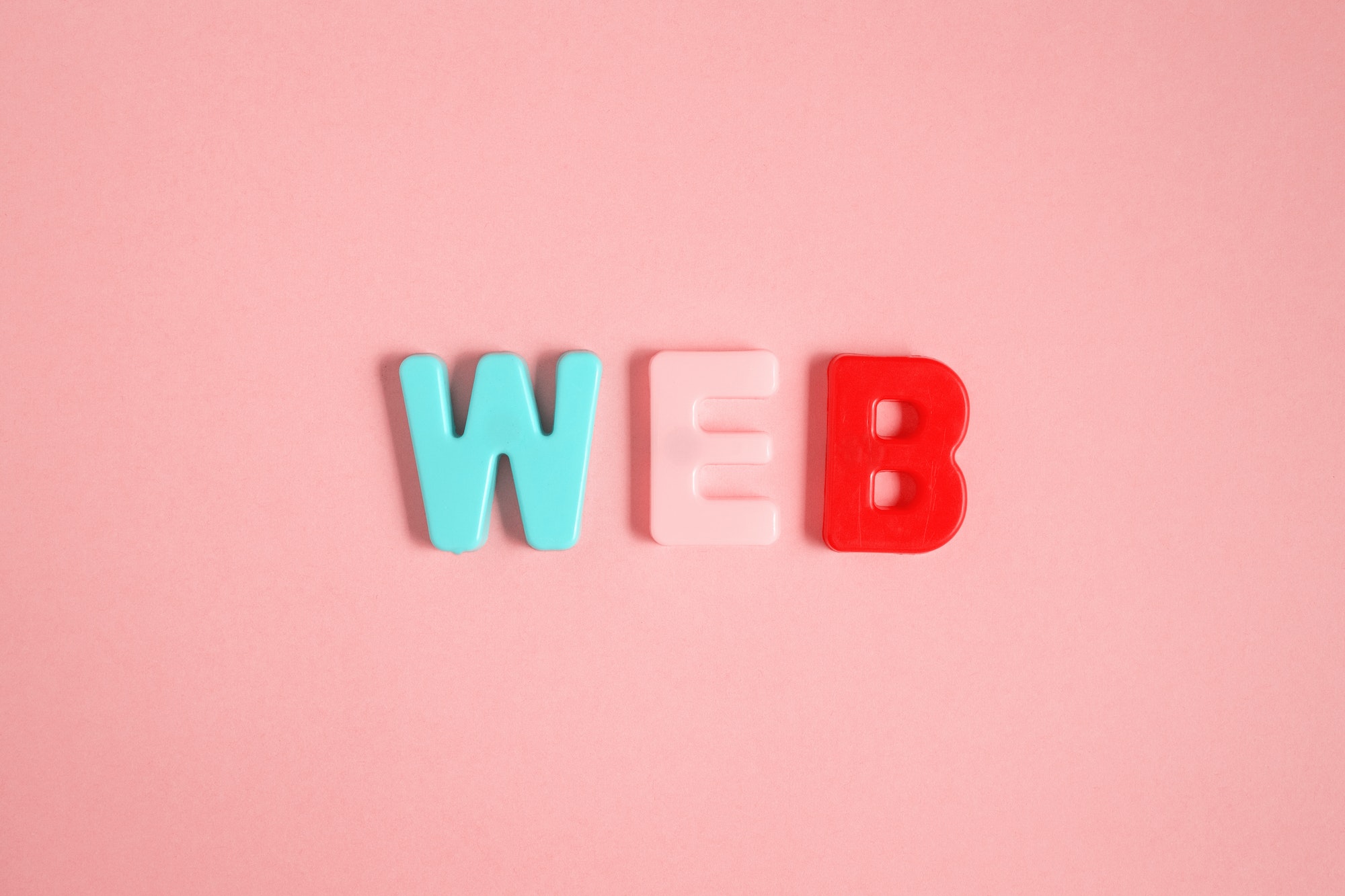 Plastic magnetic letters. The Word web on pink
